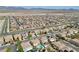 Neighborhood aerial showcasing houses with solar panels, near open desert, and mountain views at 1609 Danielle Rebecca Ave, North Las Vegas, NV 89086