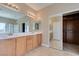 Bright bathroom featuring double sinks, a large mirror, and a glass-enclosed shower, complemented by a spacious walk-in closet at 1609 Danielle Rebecca Ave, North Las Vegas, NV 89086