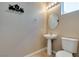 Cozy powder room includes a pedestal sink, tiled floors, and decorative wall art at 1609 Danielle Rebecca Ave, North Las Vegas, NV 89086