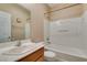 Bathroom featuring a sink, toilet, and shower-tub combination, complemented by a mirror and wooden vanity at 1609 Danielle Rebecca Ave, North Las Vegas, NV 89086