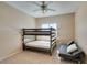 Cozy bedroom with a bunk bed and futon, illuminated by a modern ceiling fan and a window providing natural light at 1609 Danielle Rebecca Ave, North Las Vegas, NV 89086