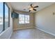 Bright bedroom with tile flooring, large window, and ceiling fan at 1609 Danielle Rebecca Ave, North Las Vegas, NV 89086