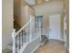 Inviting entryway with tile flooring, neutral walls, and a carpeted staircase at 1609 Danielle Rebecca Ave, North Las Vegas, NV 89086