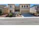 Two-story home with a two-car garage and desert landscaping at 1609 Danielle Rebecca Ave, North Las Vegas, NV 89086