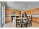 Kitchen featuring wooden cabinets, granite countertops, stainless steel appliances, and island seating at 1609 Danielle Rebecca Ave, North Las Vegas, NV 89086