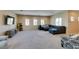 Spacious living area features plush carpeting, recessed lighting, and a comfortable sectional sofa at 1609 Danielle Rebecca Ave, North Las Vegas, NV 89086