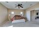 Primary bedroom featuring a ceiling fan, two windows, carpeting, and access to the bathroom at 1609 Danielle Rebecca Ave, North Las Vegas, NV 89086