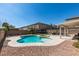Inviting backyard featuring a custom pool with jacuzzi, spacious patio, and low-maintenance landscaping at 1609 Danielle Rebecca Ave, North Las Vegas, NV 89086