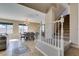 View of the dining area and carpeted staircase with white railing, illuminated by natural light at 1609 Danielle Rebecca Ave, North Las Vegas, NV 89086