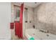 Bathroom featuring a soaking tub with stone tile surround and natural light at 1924 S 6Th St, Las Vegas, NV 89104