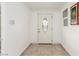 Entryway featuring a decorative glass front door, tile flooring, and a small window at 1924 S 6Th St, Las Vegas, NV 89104