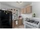 Functional kitchen with modern appliances, including a black refrigerator and white oven at 1924 S 6Th St, Las Vegas, NV 89104