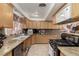 Bright kitchen showcases wood cabinets, granite counters, and stainless steel microwave at 1924 S 6Th St, Las Vegas, NV 89104