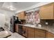 Bright kitchen with stainless steel appliances, wood cabinets, and tile flooring at 1924 S 6Th St, Las Vegas, NV 89104
