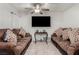 Cozy living room featuring two sofas, accent pillows, tile floors, and ceiling fan at 1924 S 6Th St, Las Vegas, NV 89104