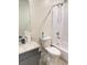 Bathroom features a vanity with granite countertop, toilet, and shower-tub combo with white tiling at 1926 Neoga St, Las Vegas, NV 89115