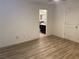 This open bedroom has new, wood-style flooring and a view of the bathroom at 1926 Neoga St, Las Vegas, NV 89115