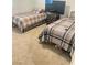 Bedroom with two beds, neutral carpet, a TV, and lots of natural light at 1926 Neoga St, Las Vegas, NV 89115