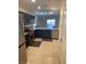 A well-lit kitchen with dark cabinets and stainless steel appliances at 1926 Neoga St, Las Vegas, NV 89115