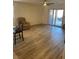 Bright living space featuring wood-look floors, a ceiling fan, and a sliding glass door to the backyard at 1926 Neoga St, Las Vegas, NV 89115