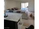 Open-concept living room with a large sectional sofa, and an island, with views of the outdoor patio at 1926 Neoga St, Las Vegas, NV 89115