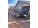 An outdoor seating area on a brick patio with swivel chairs and a fire pit at 1926 Neoga St, Las Vegas, NV 89115