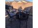 An outdoor seating area on a brick patio with swivel chairs and a fire pit at 1926 Neoga St, Las Vegas, NV 89115