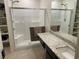 Bright bathroom featuring a glass-enclosed shower, shelving, and granite counters at 1926 Neoga St, Las Vegas, NV 89115