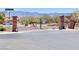 Beautiful gated community entrance with stone pillars and manicured landscaping at 2175 Limestone Cove Ct, Laughlin, NV 89029