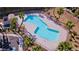 Aerial view of a modern pool with palm trees and a secure fence, perfect for relaxation and recreation at 2175 Limestone Cove Ct, Laughlin, NV 89029
