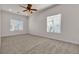Spacious carpeted bedroom with large windows and a ceiling fan at 2572 Favorable Pointe Ct, Henderson, NV 89052
