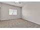 Bedroom with plush carpeting, a large window, and neutral decor at 2572 Favorable Pointe Ct, Henderson, NV 89052