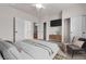 Bedroom features a bed, large tv, and an adjoining bathroom and closet at 2572 Favorable Pointe Ct, Henderson, NV 89052