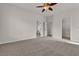 A bright, empty bedroom with carpet, a ceiling fan, and a walk-in closet at 2572 Favorable Pointe Ct, Henderson, NV 89052
