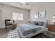 Staged bedroom with neutral tones, large bed, modern art, and plenty of natural light at 2572 Favorable Pointe Ct, Henderson, NV 89052