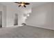 Bright bedroom with carpet, a ceiling fan, a door and small staircase at 2572 Favorable Pointe Ct, Henderson, NV 89052