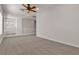 Large, carpeted bonus room with railing and ceiling fan at 2572 Favorable Pointe Ct, Henderson, NV 89052