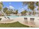 Inviting community pool surrounded by lounge chairs and lush landscaping, perfect for relaxation and recreation at 2572 Favorable Pointe Ct, Henderson, NV 89052