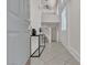 Inviting home entryway showcasing tile floors, a console table, and an open staircase at 2572 Favorable Pointe Ct, Henderson, NV 89052