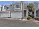 Contemporary townhome with gray stucco and white trim, plus a two-car garage at 2572 Favorable Pointe Ct, Henderson, NV 89052