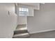 A small hallway with natural light from the window and two carpeted steps at 2572 Favorable Pointe Ct, Henderson, NV 89052