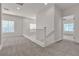 Hallway with plush carpeting, a banister, and natural light from the windows at 2572 Favorable Pointe Ct, Henderson, NV 89052