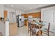 Open kitchen with stainless steel appliances and wooden cabinetry, adjacent to dining area at 2572 Favorable Pointe Ct, Henderson, NV 89052