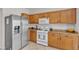 Kitchen featuring stainless steel refrigerator, a white oven and cabinets at 2572 Favorable Pointe Ct, Henderson, NV 89052