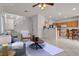 Staged living room featuring neutral tones and an open layout into the kitchen and staircase at 2572 Favorable Pointe Ct, Henderson, NV 89052