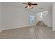 Bright living area with tile floors, ceiling fan, and staircase leading to the upper level at 2572 Favorable Pointe Ct, Henderson, NV 89052