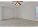 Spacious living room featuring tile flooring, neutral walls, and a ceiling fan with overhead lighting at 2572 Favorable Pointe Ct, Henderson, NV 89052