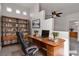 Bright office space with a desk, shelves, and a view into the bathroom at 2572 Favorable Pointe Ct, Henderson, NV 89052