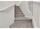 Carpeted staircase with white banister at 2572 Favorable Pointe Ct, Henderson, NV 89052