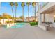 Backyard featuring a pool, spa, outdoor kitchen, and lush landscaping, ideal for entertaining and relaxation at 2694 Caumsett Ct, Las Vegas, NV 89117